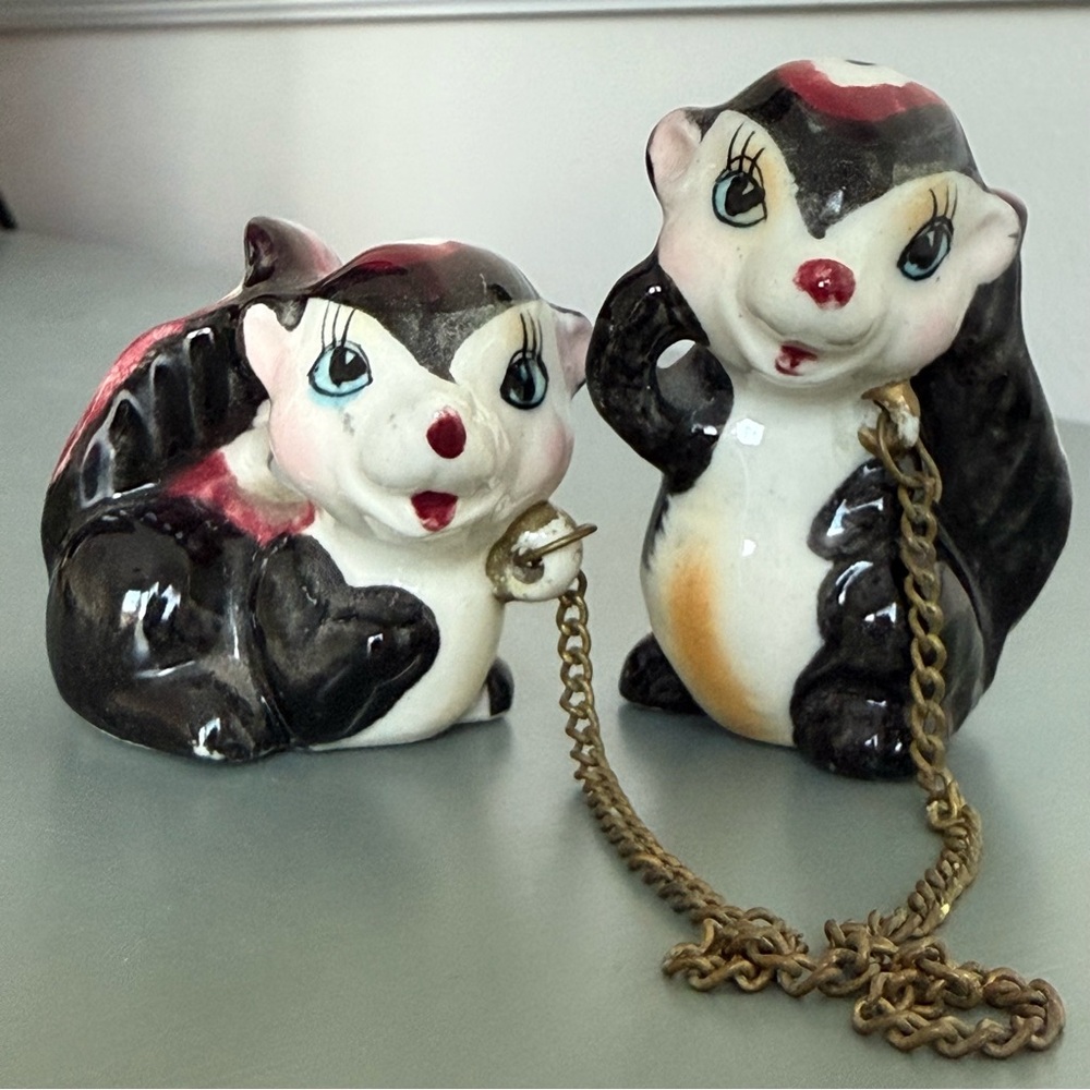 Vintage skunks connected by chain